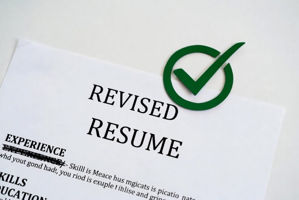 a white paper showing tick checkmark against words revised resume, resume skills