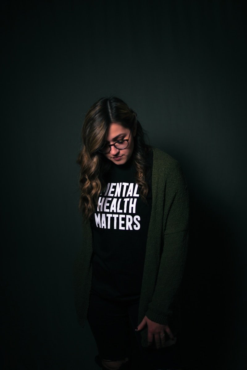 woman in black and white long sleeve shirt with words 'Mental Health Matters'. Wellness at work