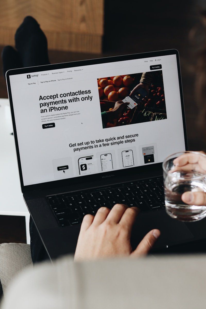 A person sitting on a couch using a laptop computer